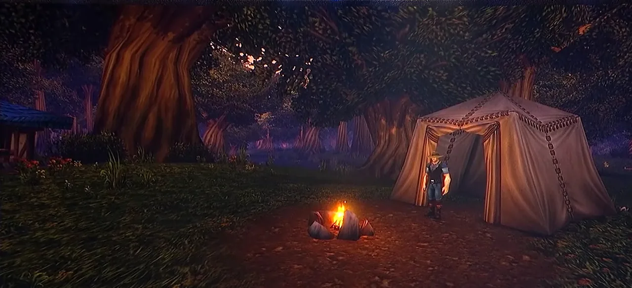 Campement en jeu affiché sur l’écran de la scène du Deep Dive : une tente en toile et un feu de camp allumé sous un grand arbre au crépuscule, avec un personnage à côté de la tente